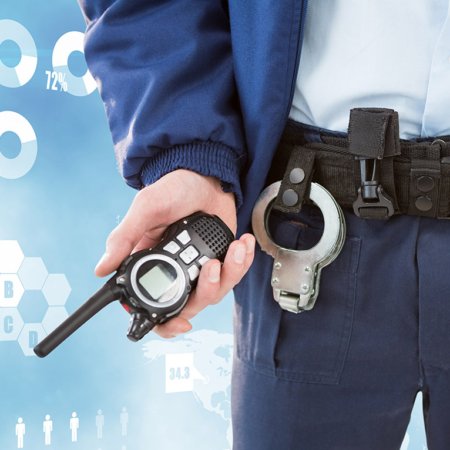 Midsection of security guard holding radio
