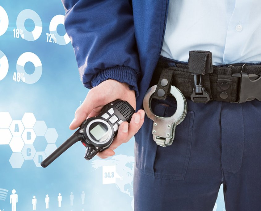 Midsection of security guard holding radio